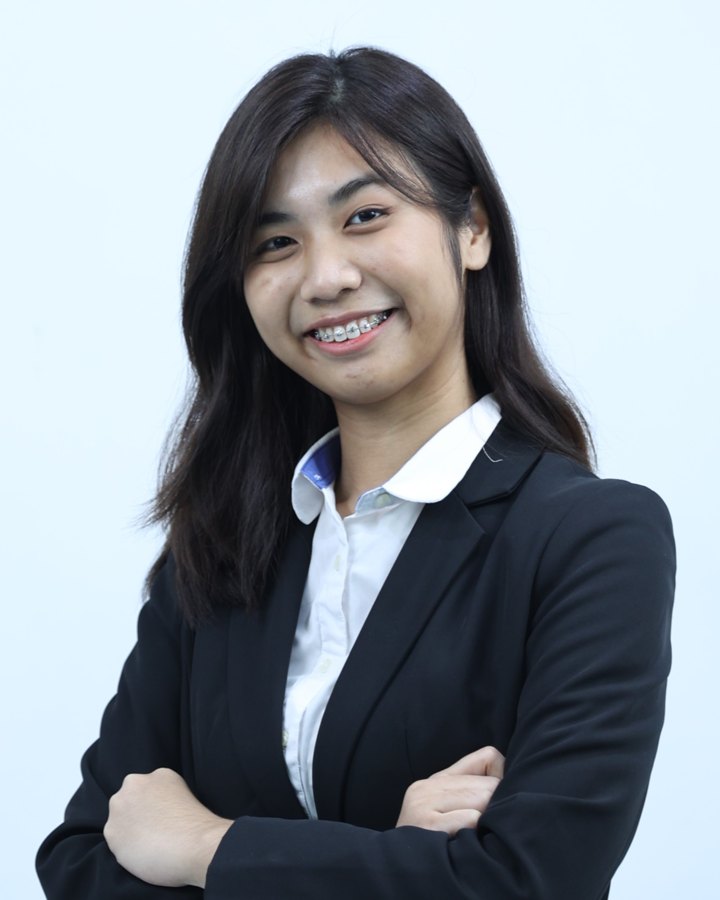 Portrait of Shu Lyn smiling, wearing a black blazer